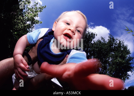 Baby reaches out to the camera Stock Photo