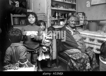 Painet ha1425 250 black and white elderly aging grandmother children crowded tenement dwelling tepito mexico hispanic city Stock Photo
