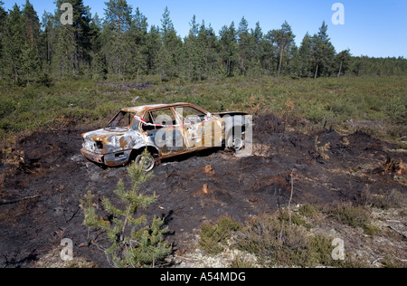 Stolen and burned car in the forest , Finland Stock Photo