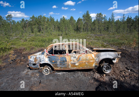 Stolen and burned car in the forest , Finland Stock Photo