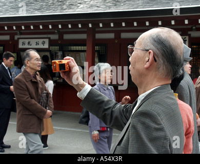 Painet ip2055 man taking photos japan visitors asakusa buddhist temple tokyo 2003 country developing nation less Stock Photo