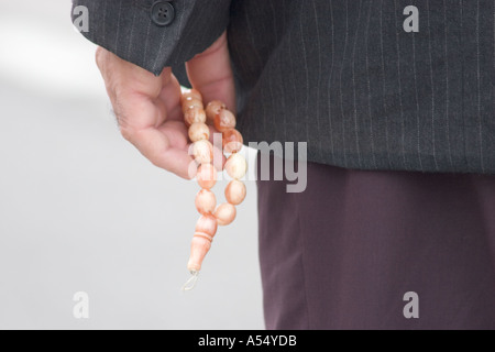 Muslim holding a prayer chain Stock Photo