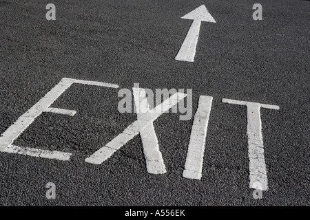 Exit sign and arrow painted on tarmac Stock Photo