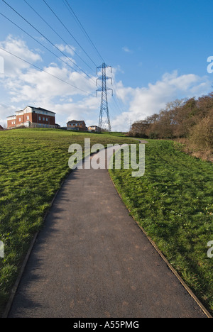Path leading to electricity pylons and houses in he distance, Cardiff. South Wales. UK Stock Photo