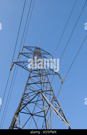 Electricity pylon and power lines with a plain blue sky. Stock Photo