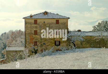 A Tuscan farmhouse in a sugary landscape after a morning snowfall matches the spring photo Stock Photo