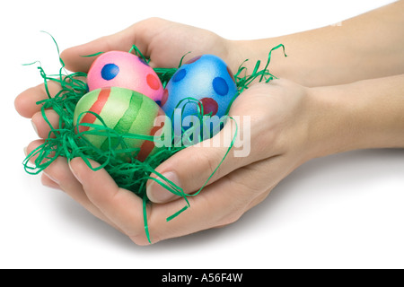Female hands holding three Easter eggs. Isolated on a white background. Stock Photo