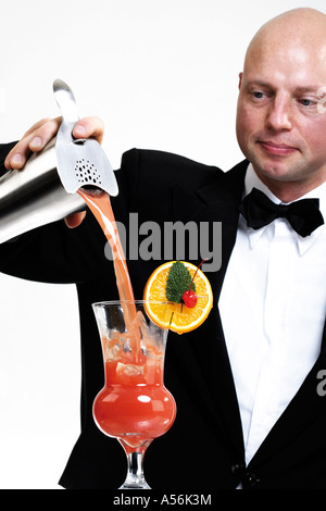 Bartender pouring cocktail into glass, portrait Stock Photo