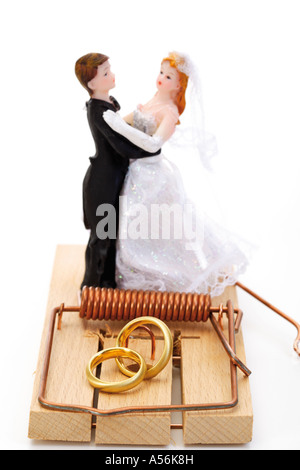 Wedding couple figurines standing on mouse trap, close-up Stock Photo