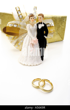 Wedding couple between wedding present and wedding rings Stock Photo