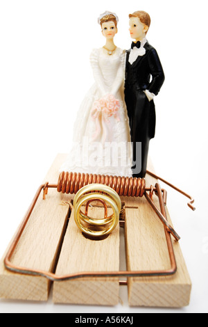 Wedding couple standing behind mouse trap, close-up Stock Photo