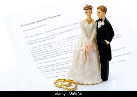 Wedding couple figurines standing on magisterial form sheet Stock Photo