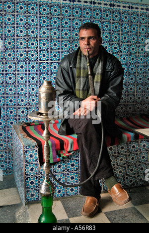 Man smoking the sheesha pipe in a cafe, Kairouan, Tunisia Stock Photo