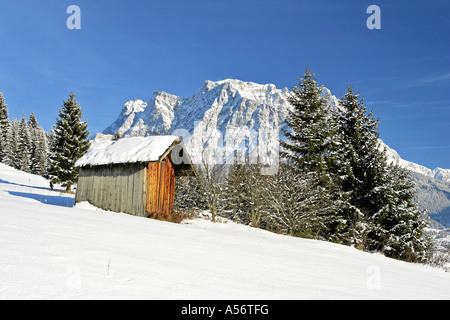 hut in front of Zugspitze in winter seen from Erwald Austria Stock Photo