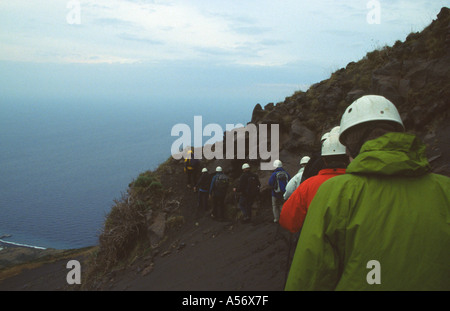 Walkers with volcanologist guide climbing Stromboli Volcano on island of Stromboli Sicily Stock Photo