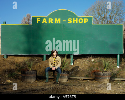 Young man outside a Farm Shop Stock Photo