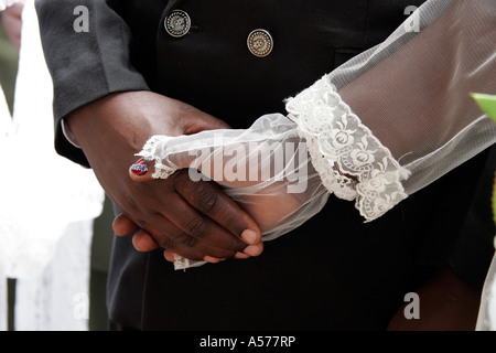 Painet jb1404 kenya bride and groom holding hands wedding mass kibera slum nairobi three couples married same time american Stock Photo