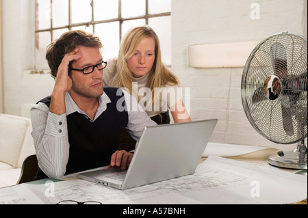 Young man and young woman working on laptop Stock Photo