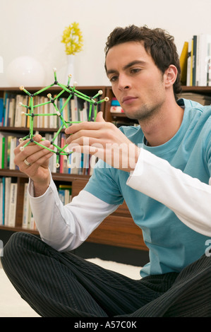 Young man holding model Stock Photo