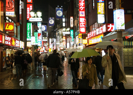 Busy street at night in Shibuya entertainment and shopping district Tokyo Japan 2006 Stock Photo