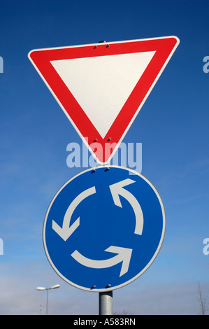 Road traffic signs Give way and Roundabout, Germany Stock Photo