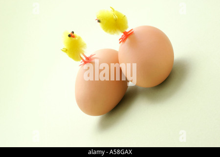 Toy Chicks Standing on Eggs Stock Photo