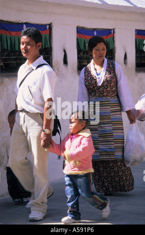 Nepali people family walking around Buddhist Stupa of Bodhnath Kathmandu Nepal Stock Photo