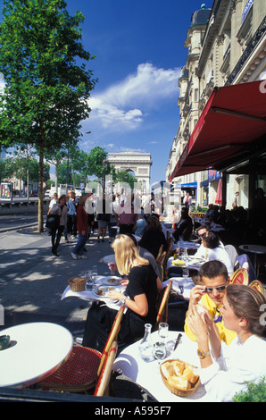 Sidewalk cafe on Champs Elysees with Arc de Triomphe in Paris Stock Photo