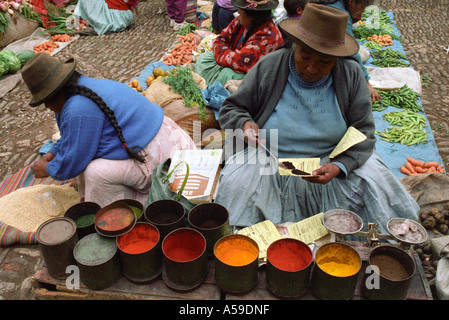 Coloured dyes on sale market day in the square Pisac Sacred Valley in Cusco Peru Stock Photo