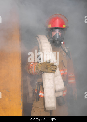 Firefighter rescue, Fireman walking out from burning building and hold ...