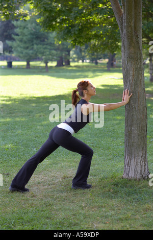 Woman Stretching in Park Stock Photo