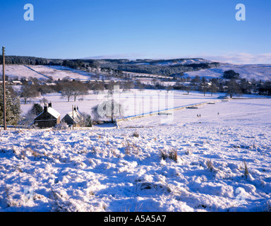 View over fields towards Falstone village in winter, Northumberland, England, UK. Stock Photo