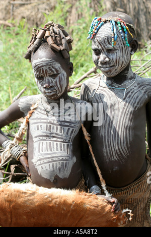 Mursi Tribe boy and girl wearing face paint, Lower Omo Valley, Ethiopia Stock Photo