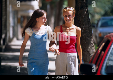 Two girls walking on the pavement in Kosovo Serbia and Montenegro Stock Photo