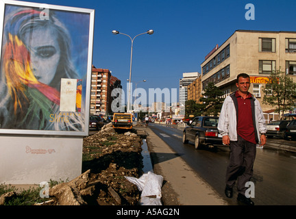 A man walking on the side of the road in Pristina Kosovo Stock Photo