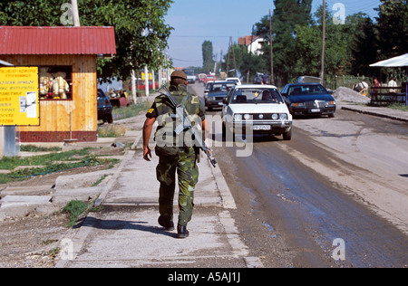 A soldier walking on the streets of the Serbian enclave in Kosovo Stock Photo
