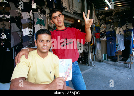 Men posing outside a clothing shop in the Shatila refugee camp in Beirut Lebanon Stock Photo