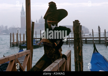 A woman dressed in a fancy costume and a mask during the Venetian Carnival Venice Italy Stock Photo