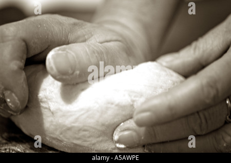 Hands kneading dough Stock Photo