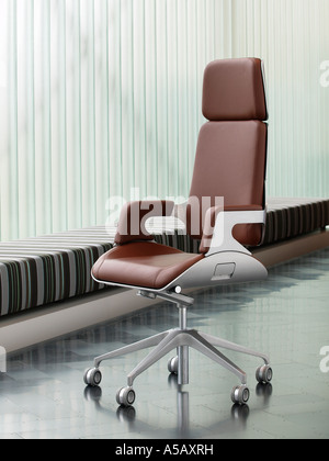 Brushed metal and brown leather luxury office chair on dark steel parquet floor design furniture Interstuhl Silver 362S Stock Photo