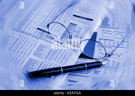 Financial newspaper pen and glasses Stock Photo