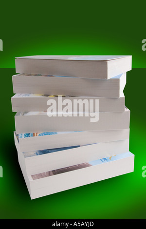 Stack of paperback books on a green background Stock Photo