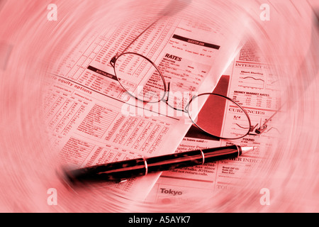 Financial newspaper pen and glasses Stock Photo
