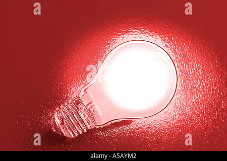 Chrome effect electric light bulb on red background Stock Photo