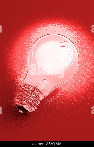 Chrome effect electric light bulb on red background Stock Photo