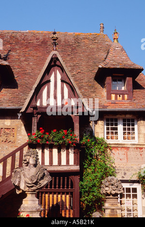 France, Dives sur Mer, Calvados, Normandy, Exterior of old stone half- timbered house with dormer windows, iron trim and mansard roof. Stock Photo