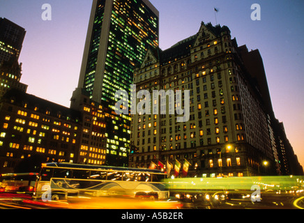 The Plaza Hotel, 5th Avenue, New York, Grand Army Plaza evening. Heavy traffic, light trails and the Solow Building on Fifth Avenue Midtown Manhattan. Stock Photo