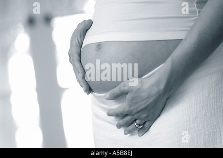 Pregnant women holding belly. Stock Photo