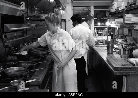 Team of restaurant kitchen staff busy at work. Stock Photo