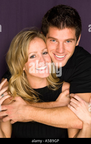 Young woman and man in love holding each other. Stock Photo